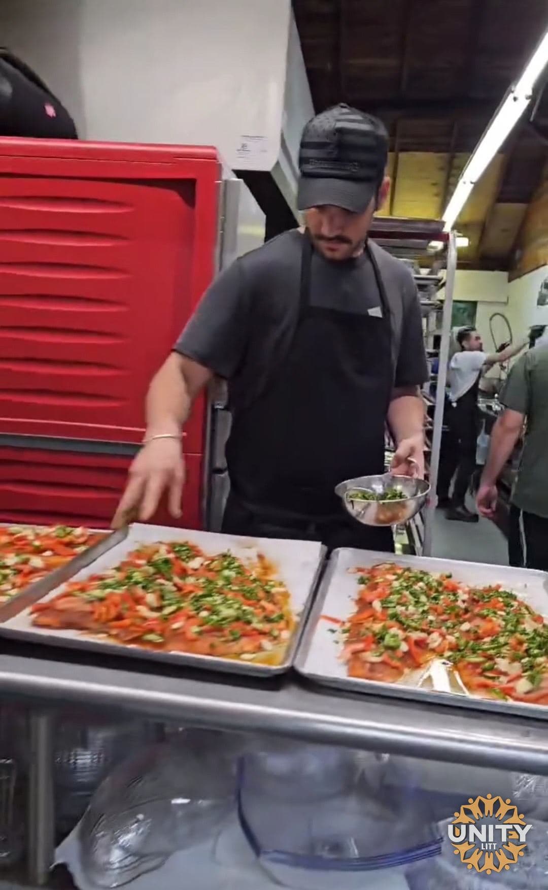 A chef plating salmon in the kitchen before service