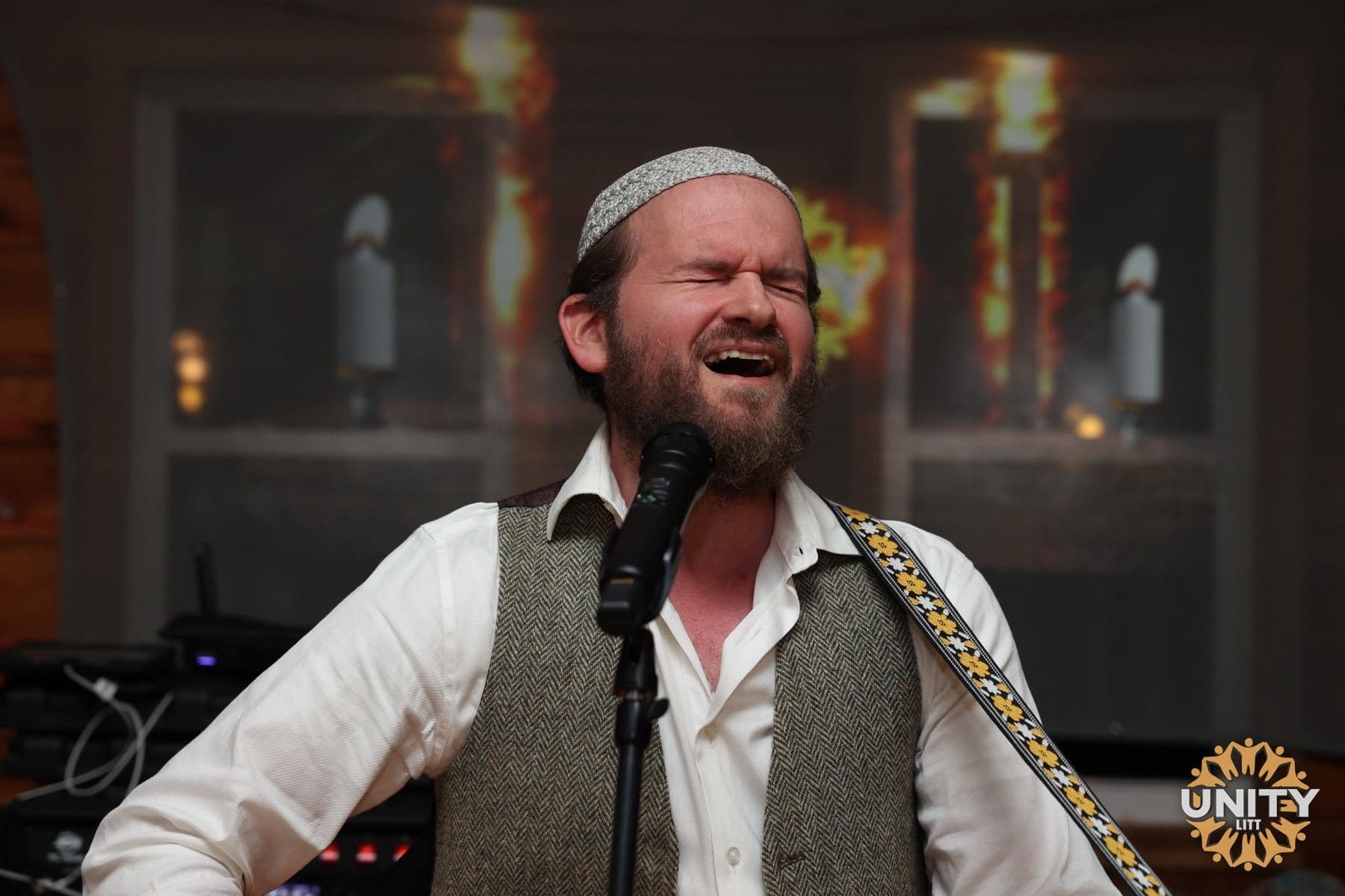 A singer photographed close in low light, lost in the music
