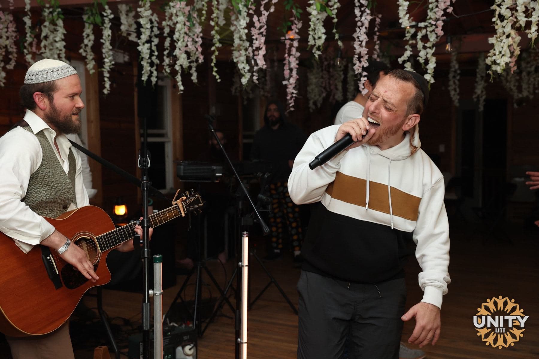 A singer and guitarist playing side by side