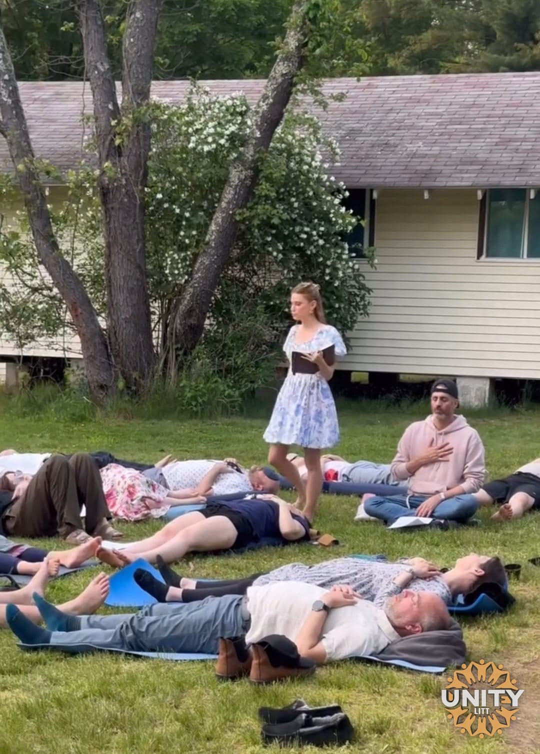 A group lying on the grass together in the afternoon